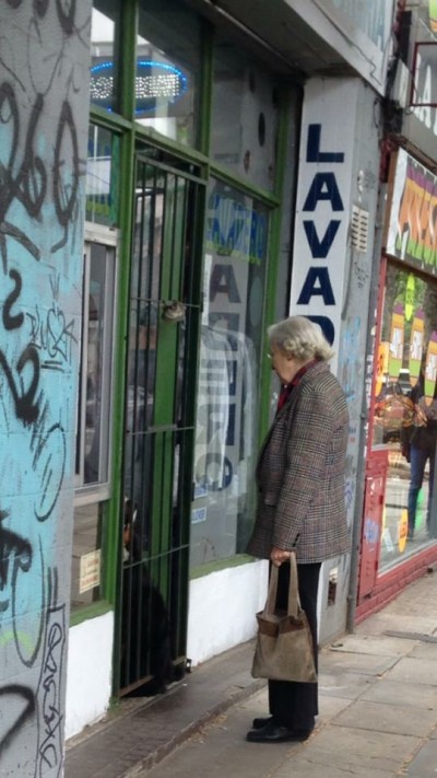 woman talking to dog through door in buenos aires